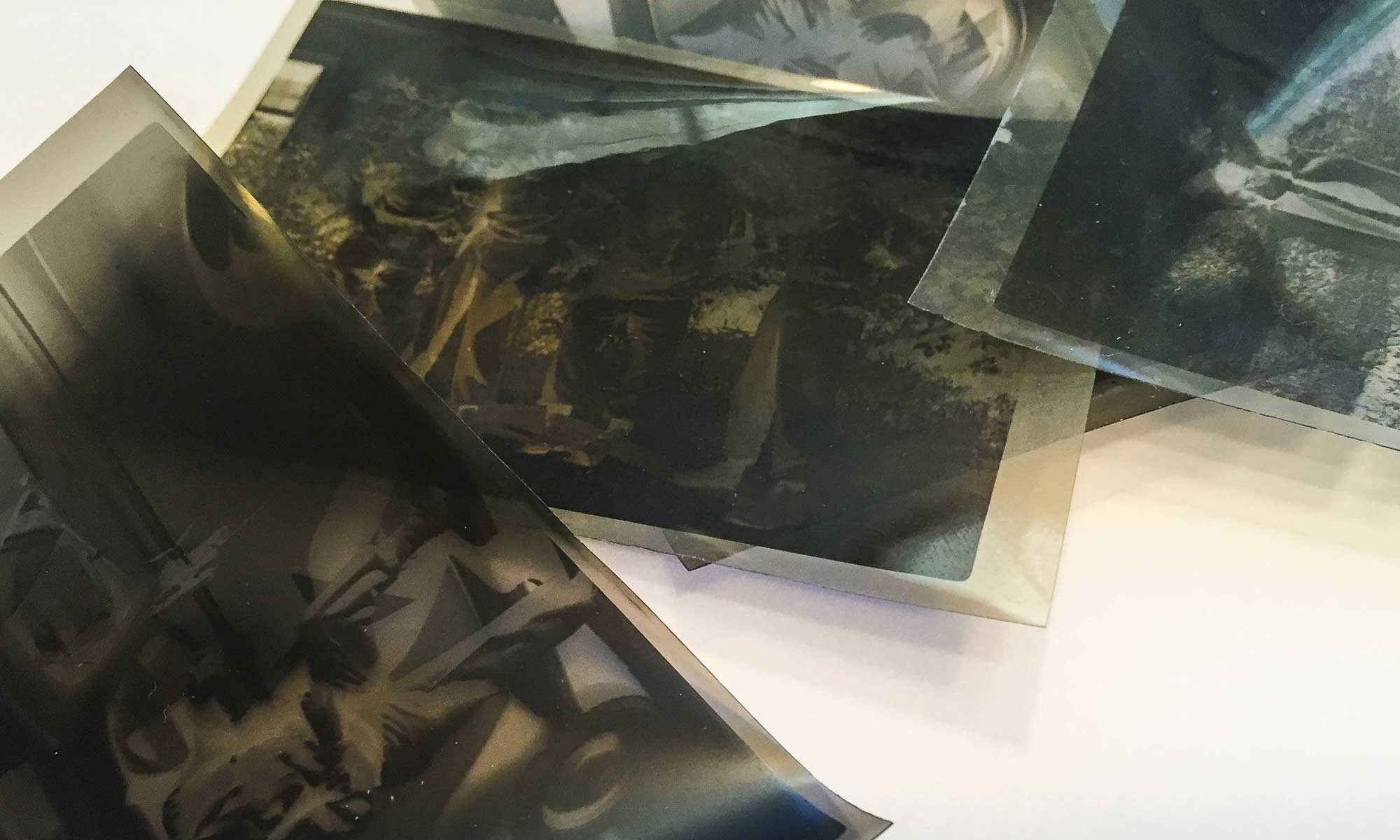 photo restoration-collection of black and white vintage negatives on table top