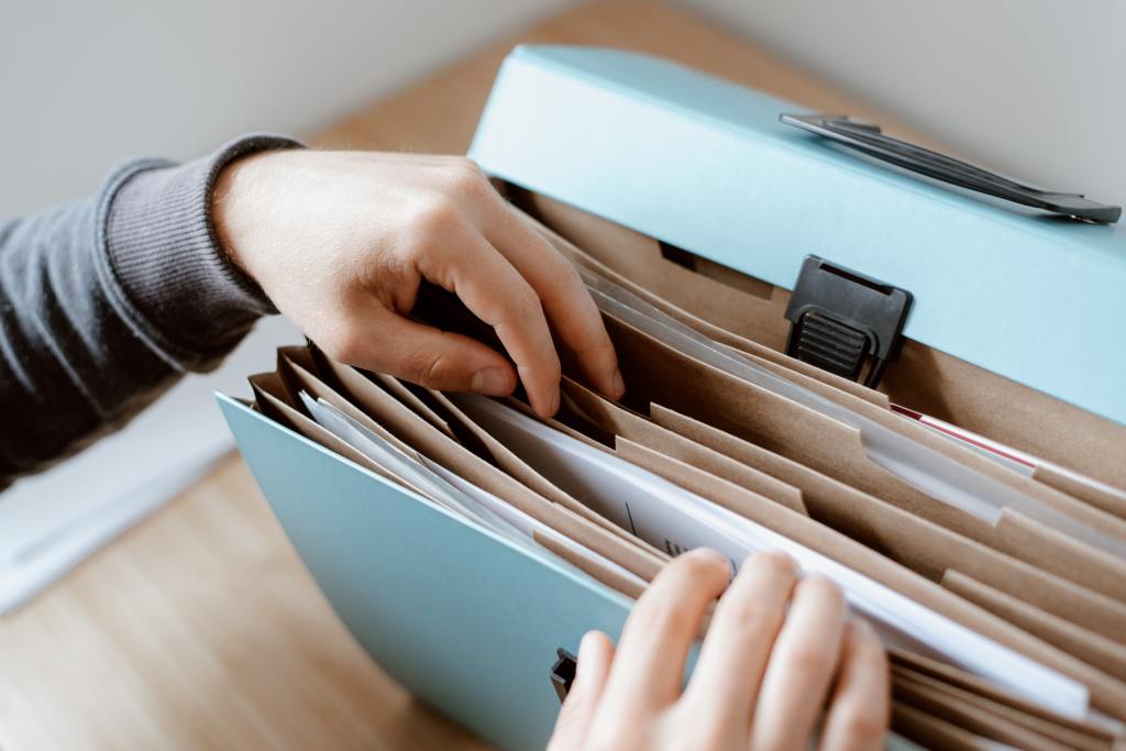 close up photograph of child leafing through a file box full of papers